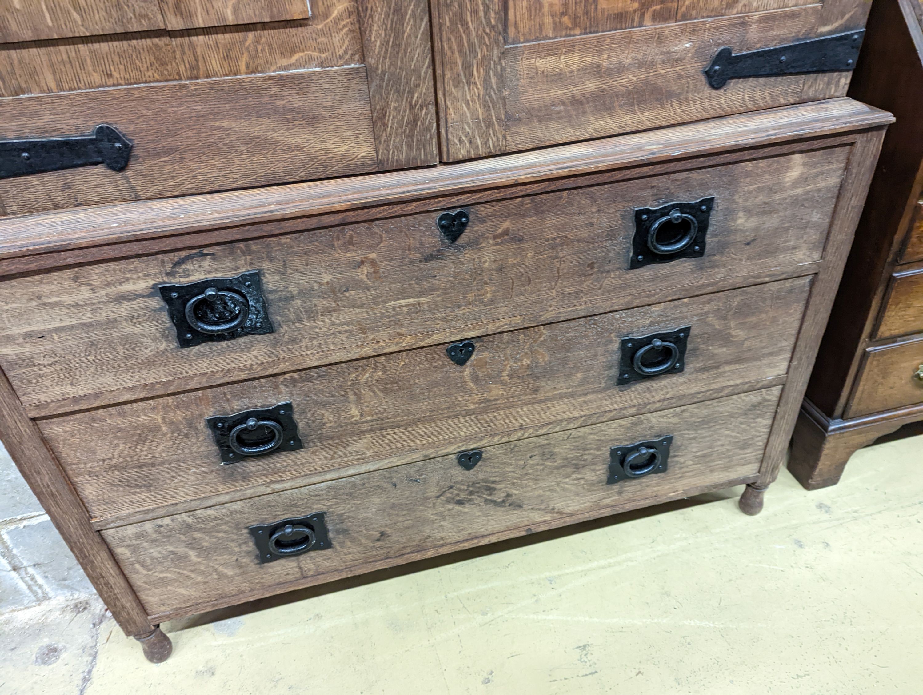 An early 20th century Arts & Crafts iron mounted oak linen press, width 140cm, depth 60cm, height 191cm